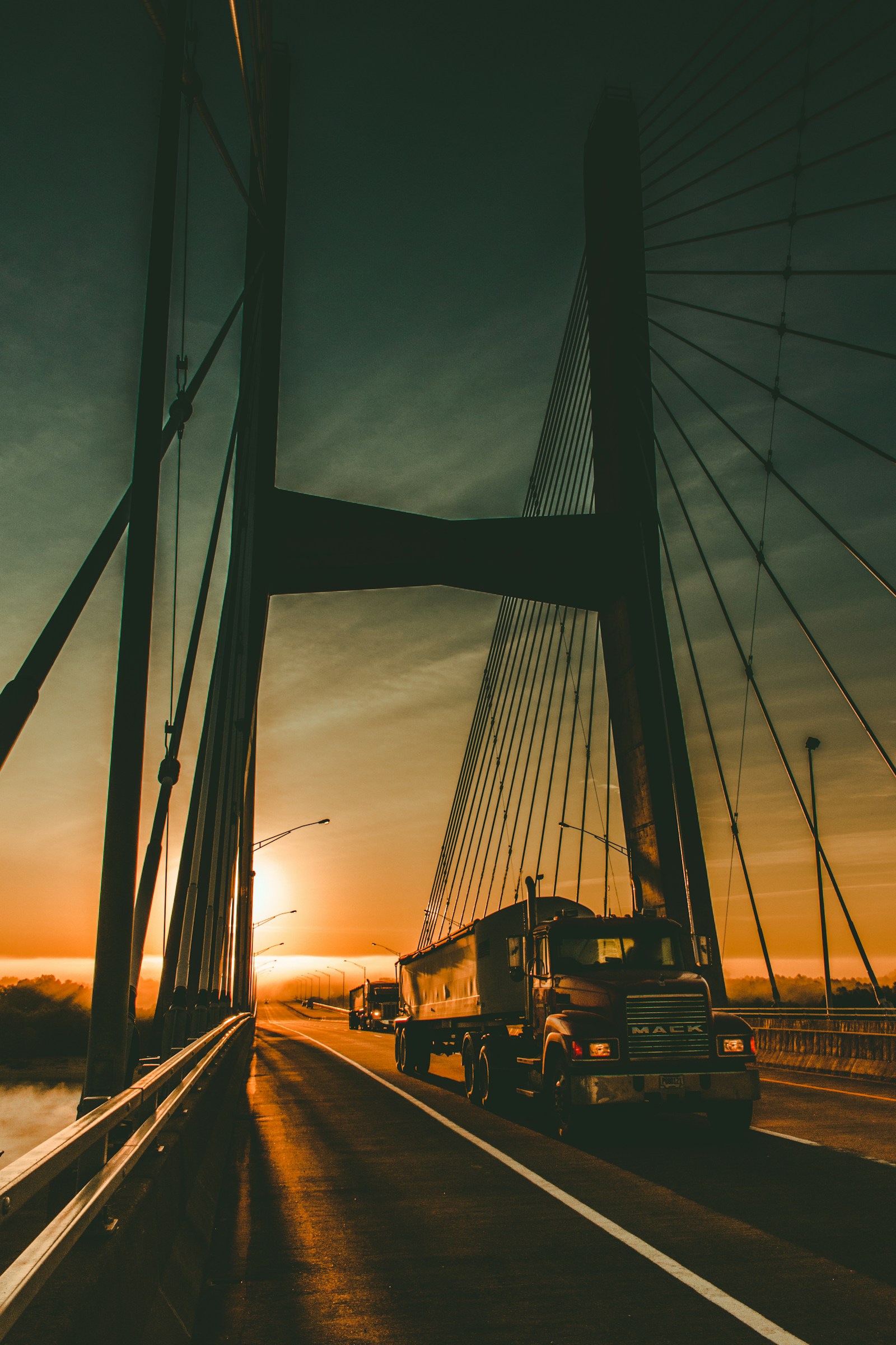 A freight truck on a long highway at dawn, evoking long-haul cross-border logistics